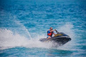 Young Man on Jet Ski, Tropical Ocean, Vacation Concept